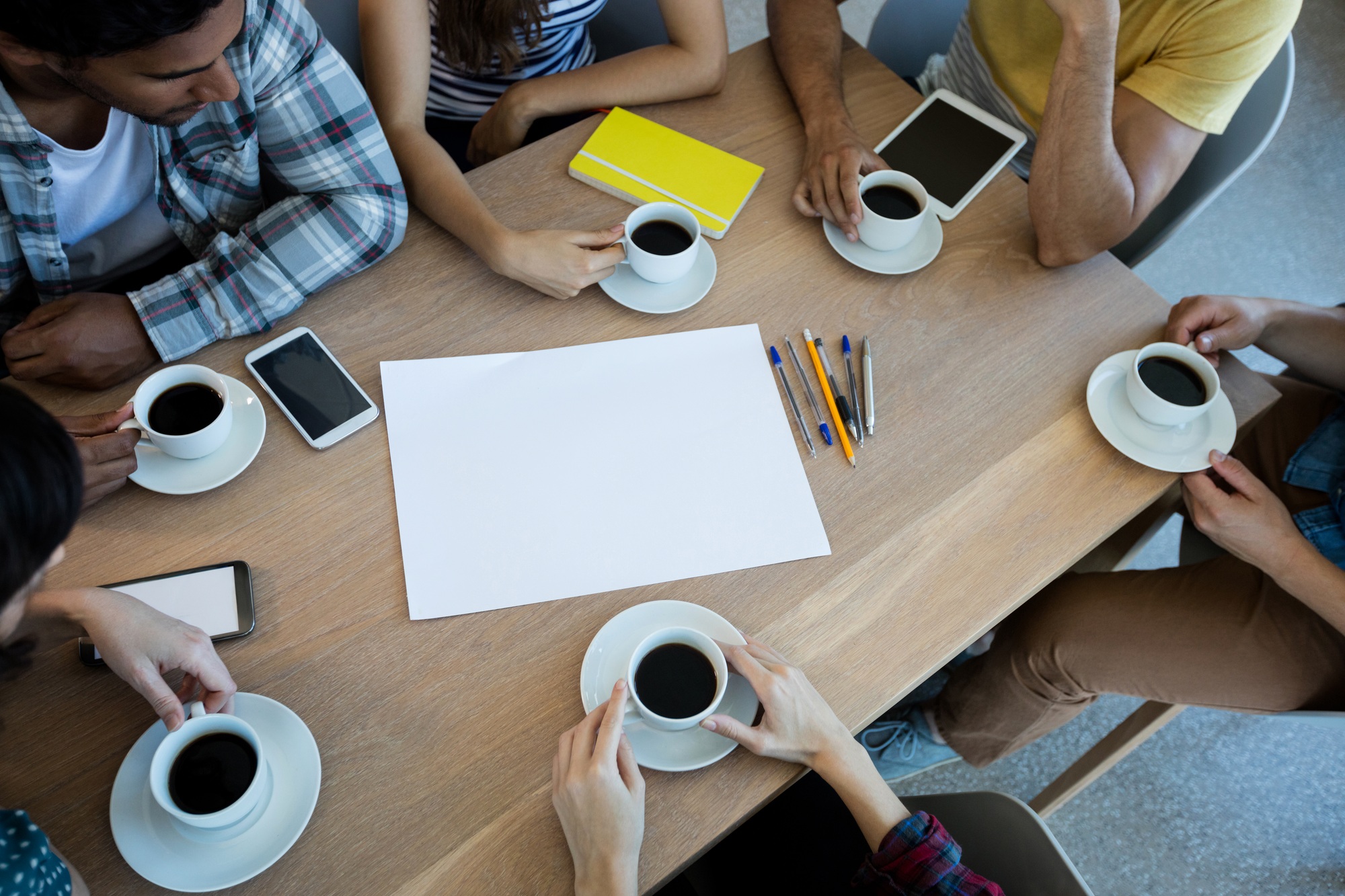 Creative business team having meeting over coffee in meeting room